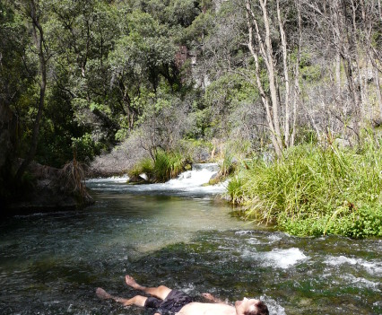 Taking a dip in the crystal clear water beneath the falls.